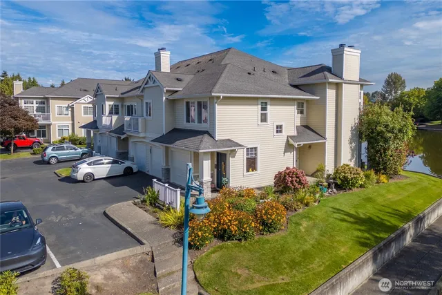 a aerial view of a house with table and chairs under an umbrella