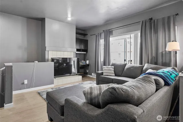 a living room with furniture and a fireplace