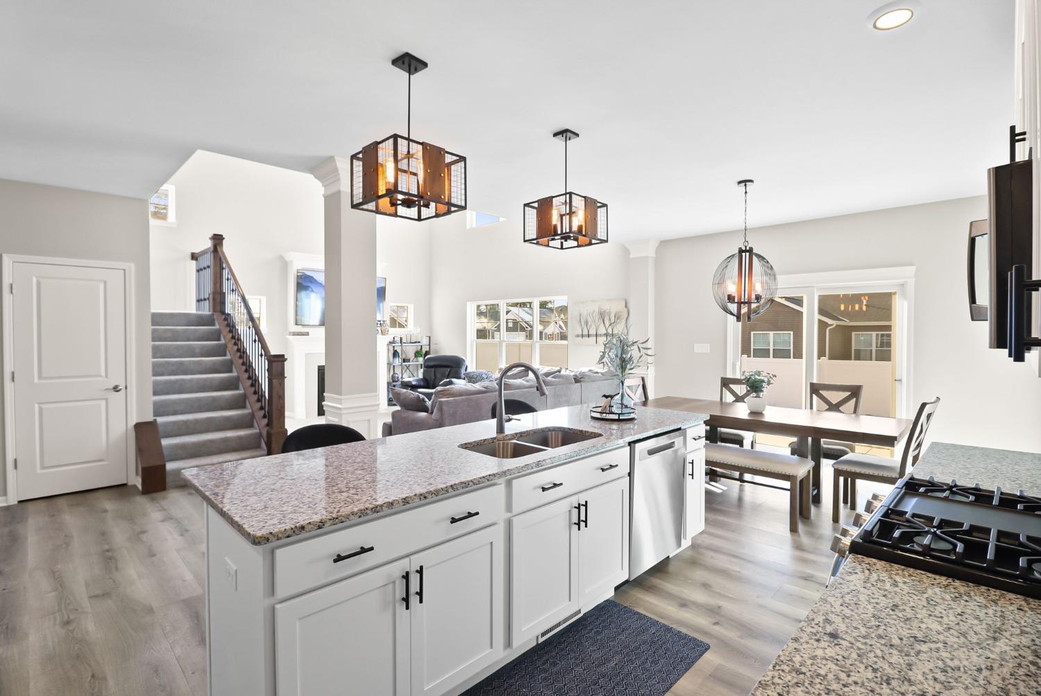2592 Ritter Street Chesterton, IN 46304 - Photo 12 of 25 a kitchen with granite countertop a sink a stove and wooden floors