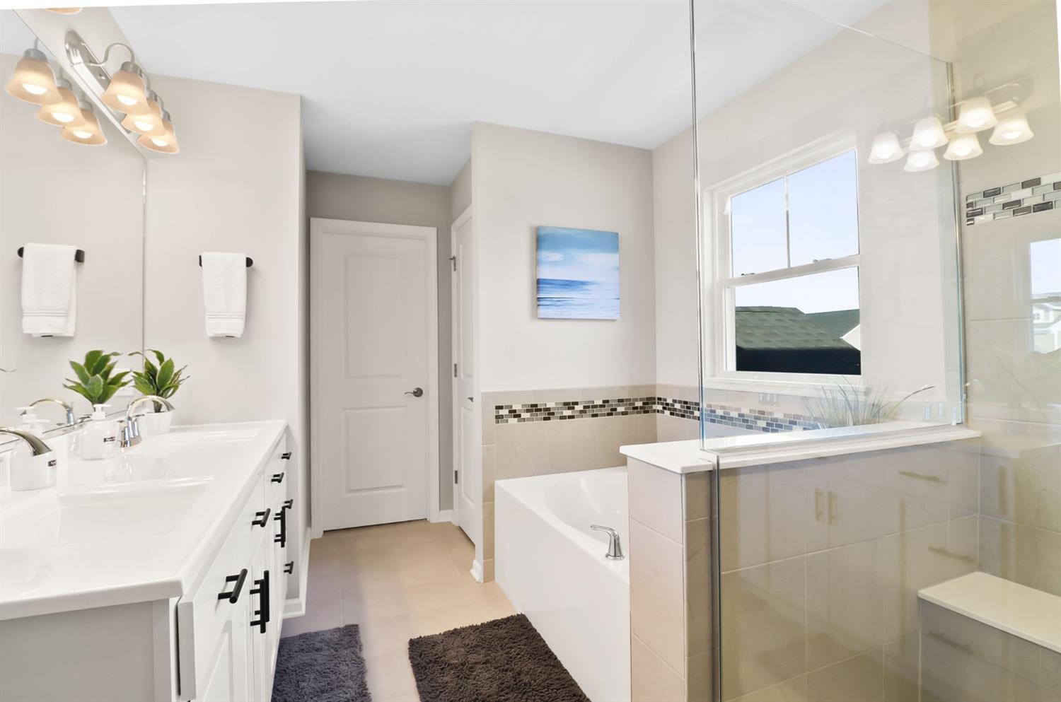 2592 Ritter Street Chesterton, IN 46304 - Photo 14 of 25 a bathroom with a double vanity sink mirror and bathtub