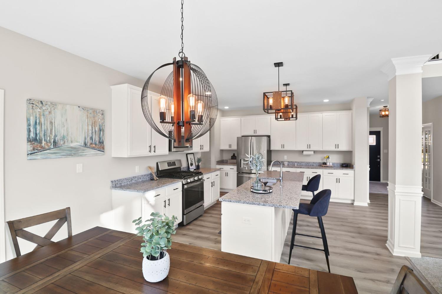 2592 Ritter Street Chesterton, IN 46304 - Photo 8 of 25 a living room with kitchen island furniture and a chandelier
