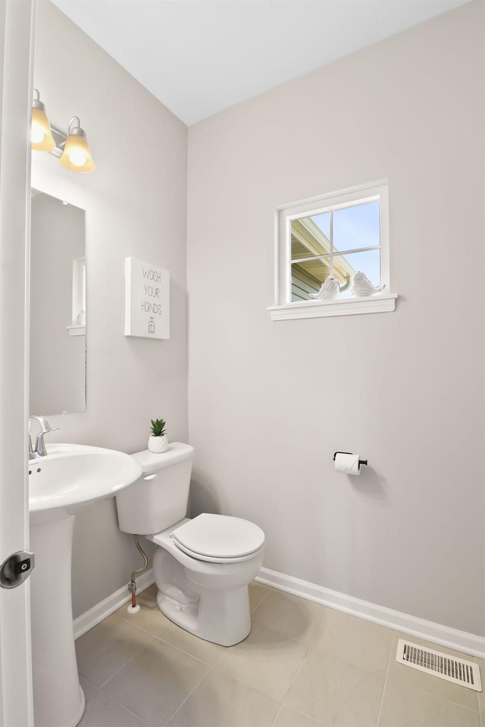 2592 Ritter Street Chesterton, IN 46304 - Photo 9 of 25 a bathroom with a toilet a sink and mirror