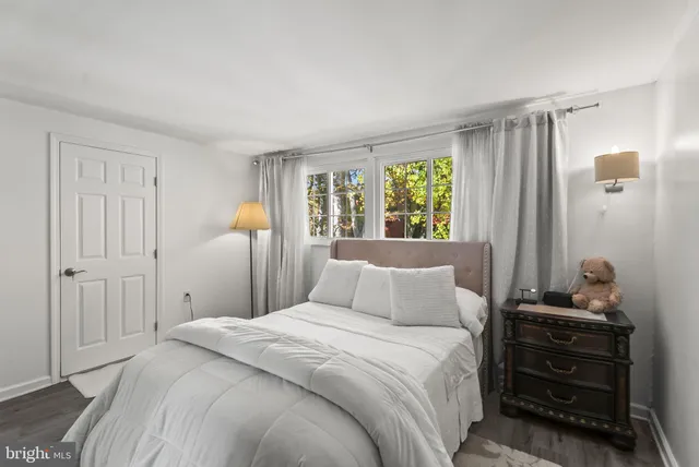 a bathroom with a granite countertop toilet sink and mirror