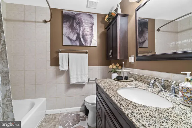 a view of a livingroom with furniture and a hallway