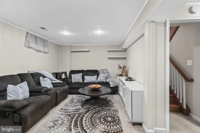 a living room with furniture and a rug