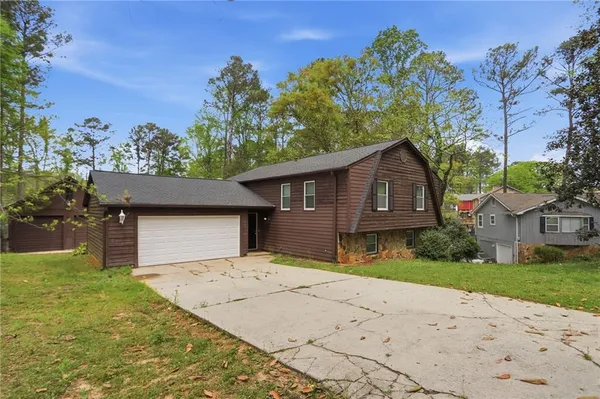 a front view of a house with a yard and garage