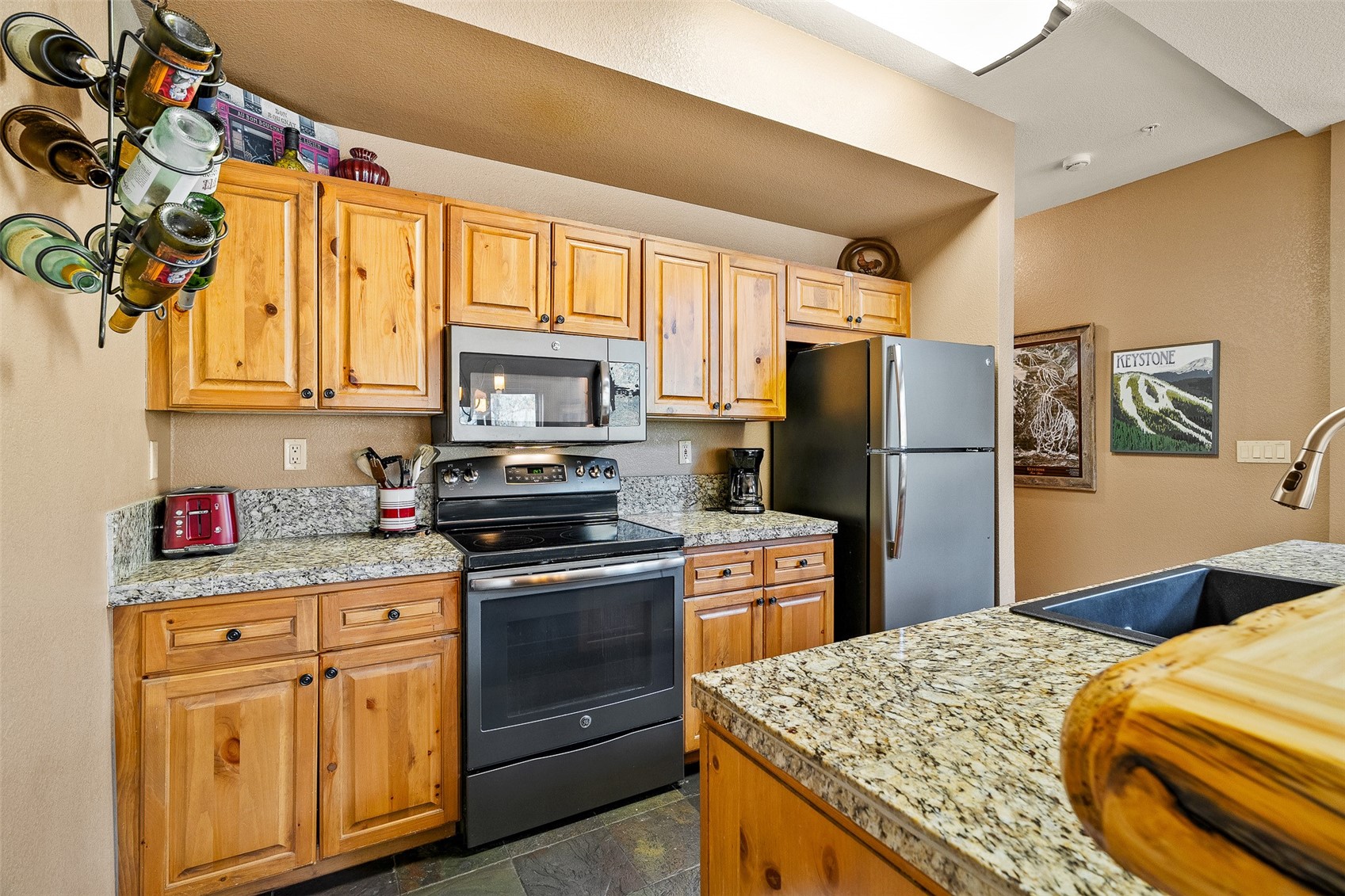 57 Lake Ridge Circle, Unit 1848 Keystone, CO 80435 - Photo 15 of 49 a kitchen with stainless steel appliances granite countertop a refrigerator sink and stove