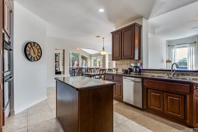 a kitchen with a sink and a stove top oven
