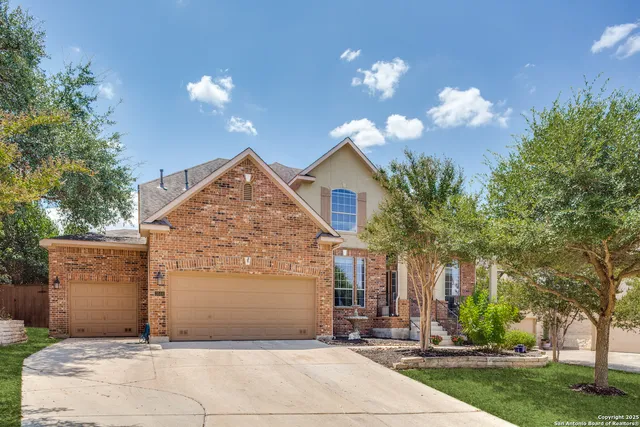 a view of a house with yard and tree s