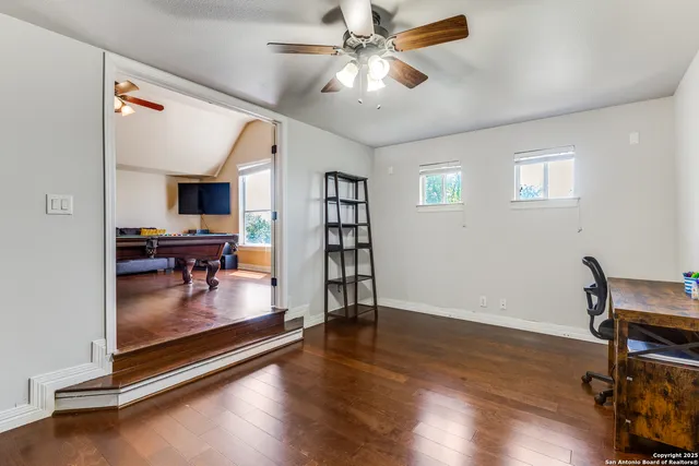 a view of a livingroom with furniture and a ceiling fan