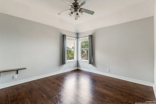 a view of a livingroom with a window and wooden floor