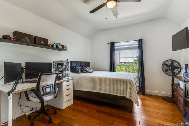 a bedroom with a bed a flat screen tv and dresser