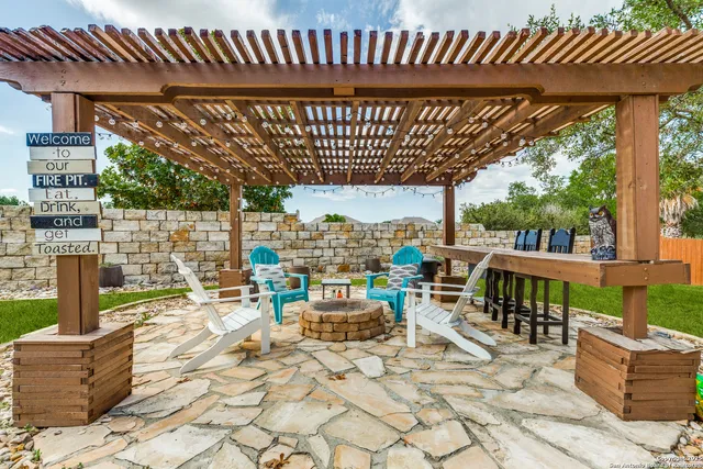 a view of a patio with a table and chairs