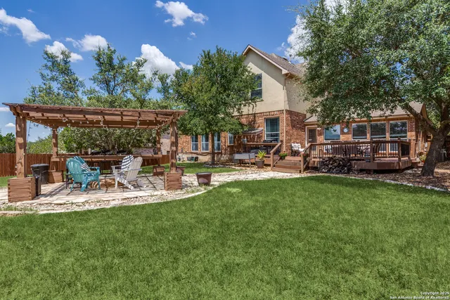 a view of a backyard with sitting area