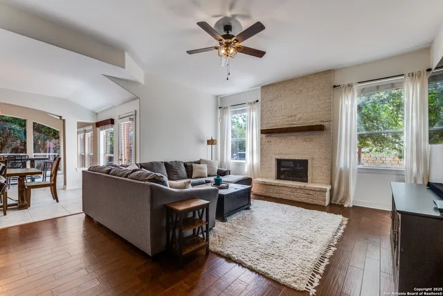 a living room with furniture and a fireplace