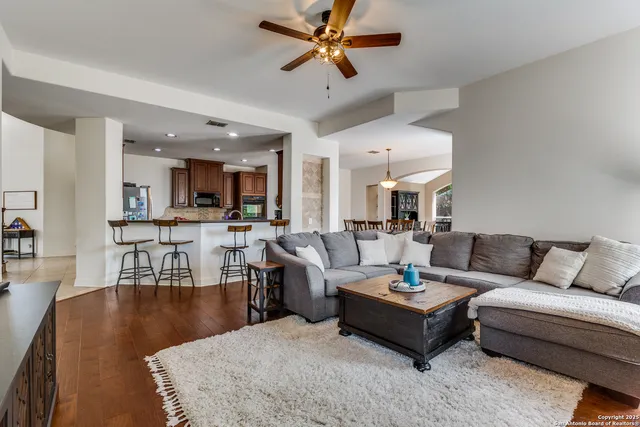 a living room with furniture kitchen view and a dining table