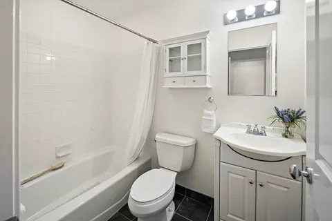 a white toilet sitting next to a bathroom sink