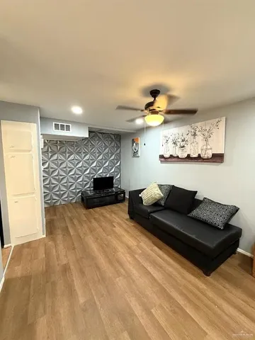 a living room with furniture and wall paintings
