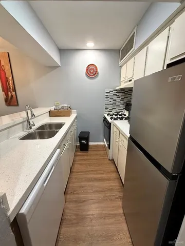 a kitchen with refrigerator and stove