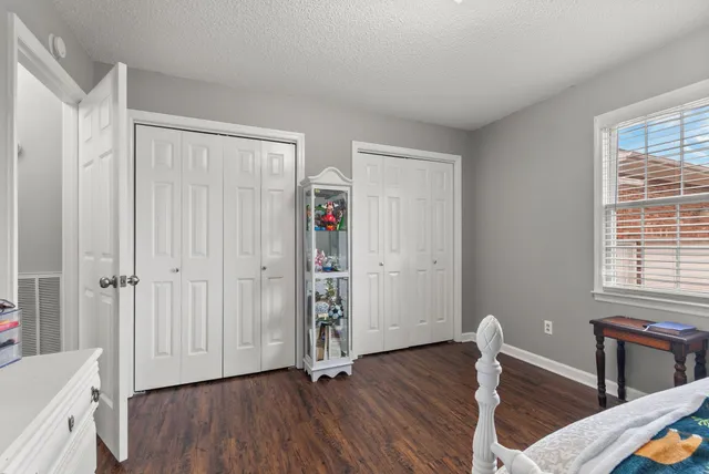 a view of a room with wooden floor lounge chair and windows