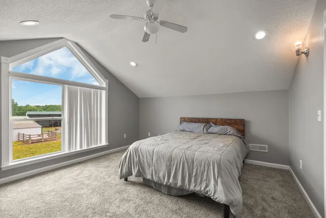 a bed sitting in a room next to a window