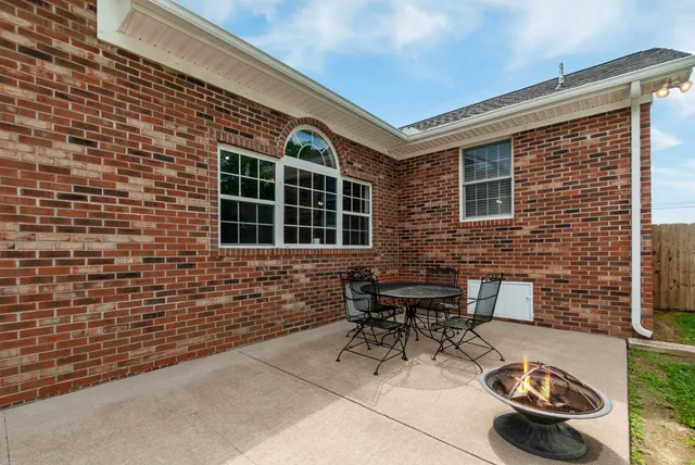a view of a patio with table and chairs and potted plants