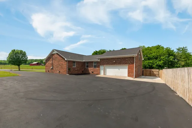 a car parked in front of house with a yard