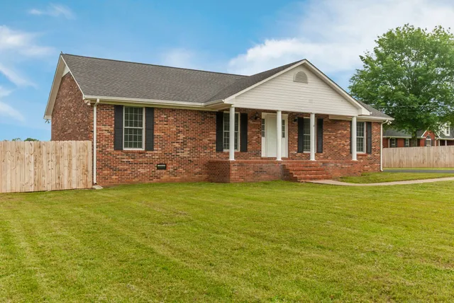 a front view of a house with a garden and porch
