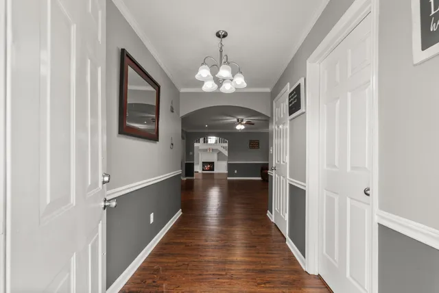 a view of a hallway with chandelier