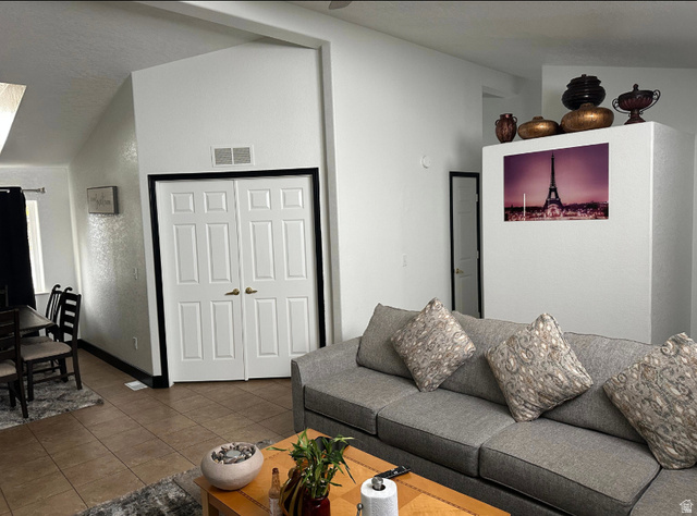 265 Mindella Way Layton, UT 84041 - Photo 14 of 32 Open-concept living space featuring vaulted ceilings and neutral-toned walls