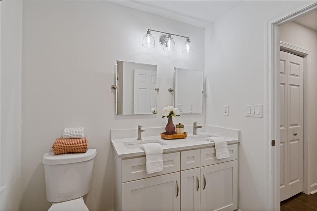 2226 Alpha Drive Decatur, GA 30032 - Photo 17 of 36 a bathroom with a toilet sink vanity and mirror