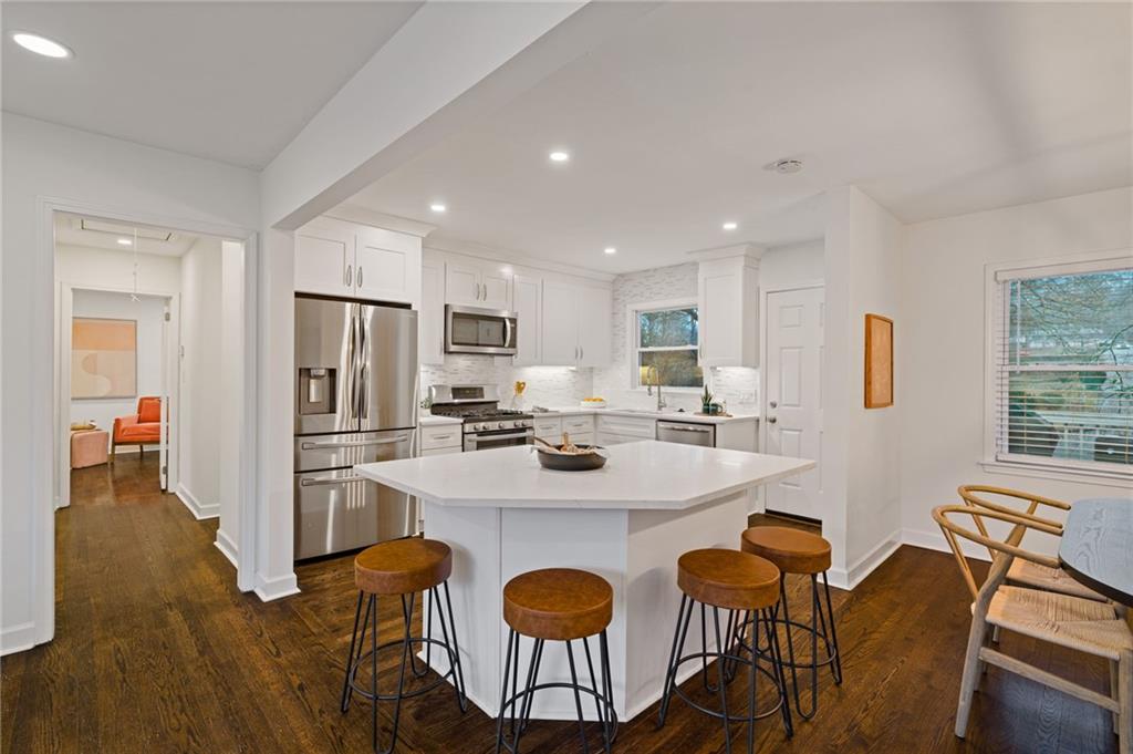 2226 Alpha Drive Decatur, GA 30032 - Photo 3 of 36 a kitchen with stainless steel appliances granite countertop a dining table chairs refrigerator and wooden cabinets