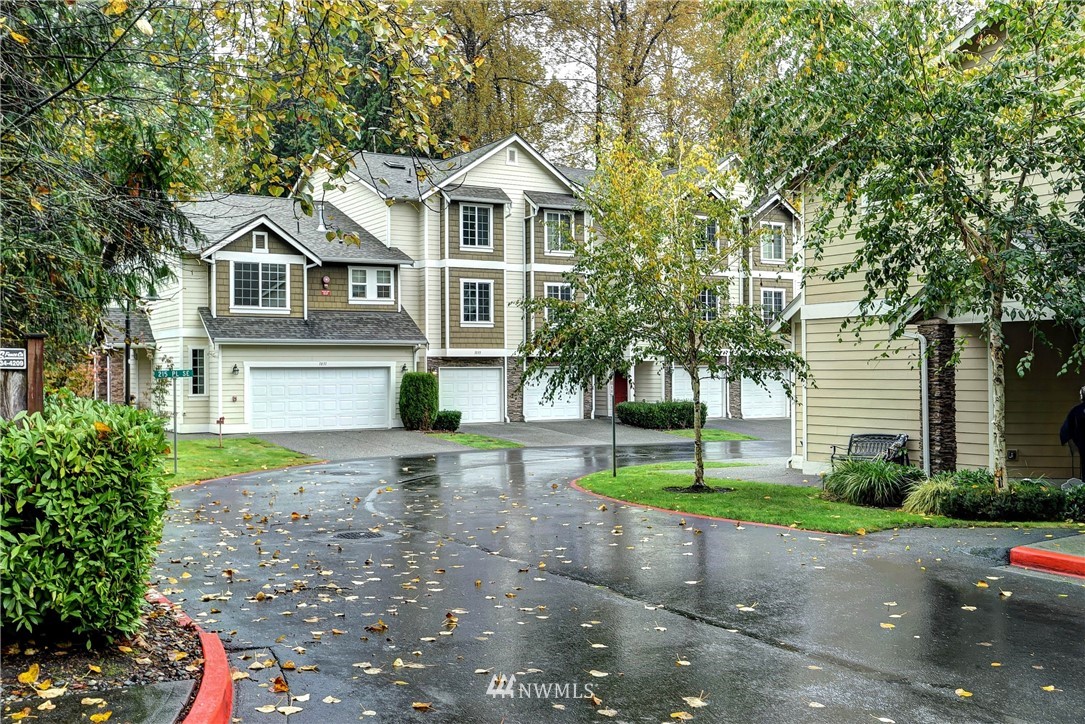 1031 215th Place Southeast Bothell, WA 98021 - Photo 1 of 25 a front view of a house with a yard and garage