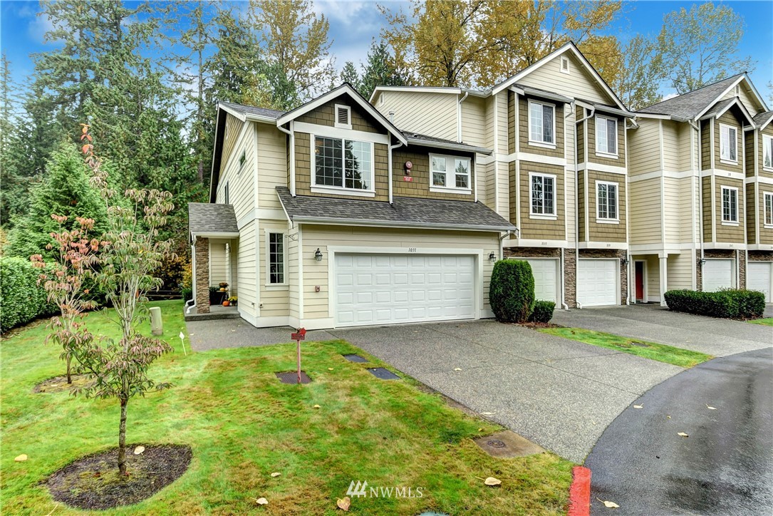1031 215th Place Southeast Bothell, WA 98021 - Photo 2 of 25 a front view of a house with a yard and garage