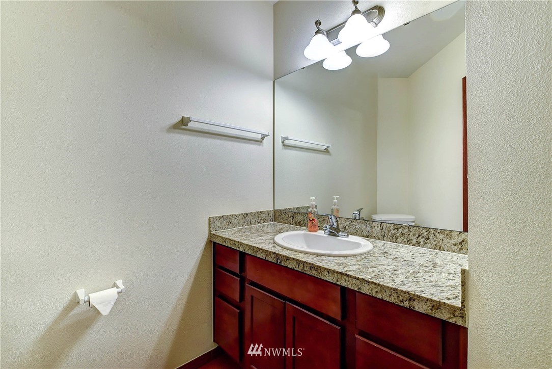 1031 215th Place Southeast Bothell, WA 98021 - Photo 12 of 25 a bathroom with a granite countertop sink and a mirror