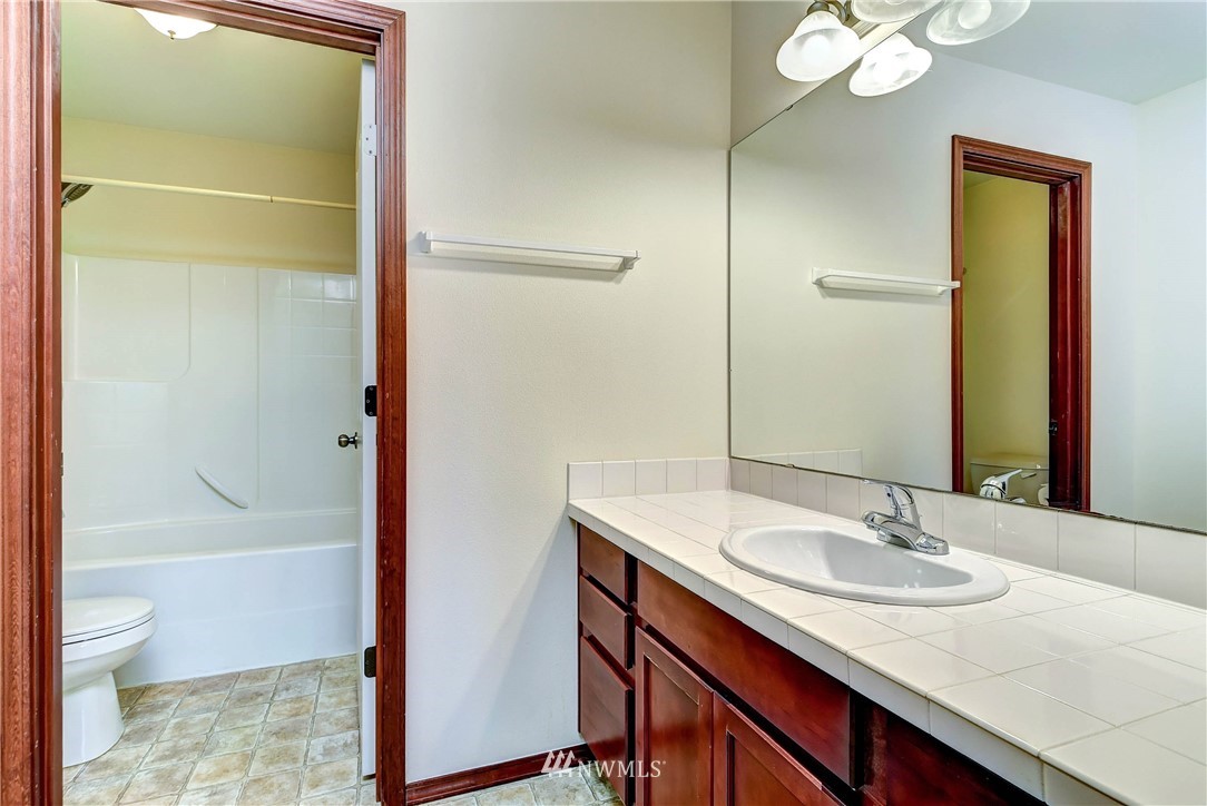 1031 215th Place Southeast Bothell, WA 98021 - Photo 13 of 25 a bathroom with a sink and a mirror