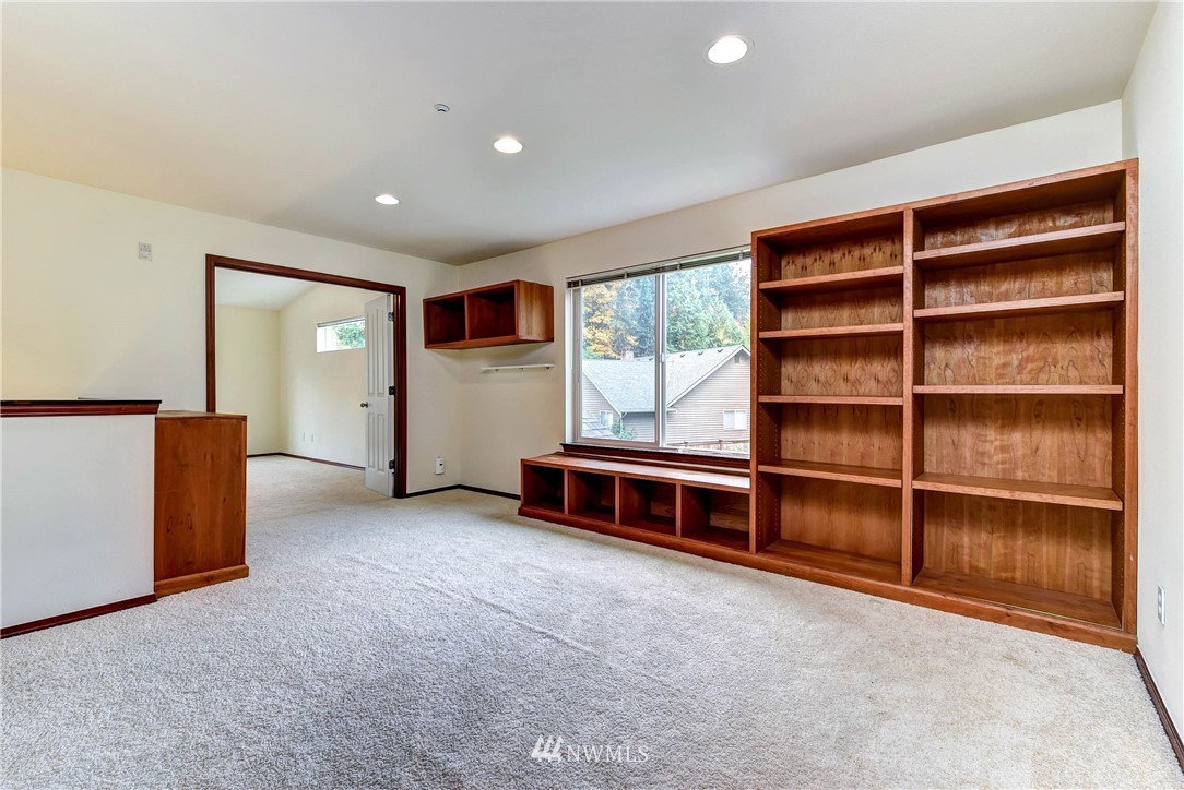 1031 215th Place Southeast Bothell, WA 98021 - Photo 14 of 25 a view of an empty room with a window and a cabinet