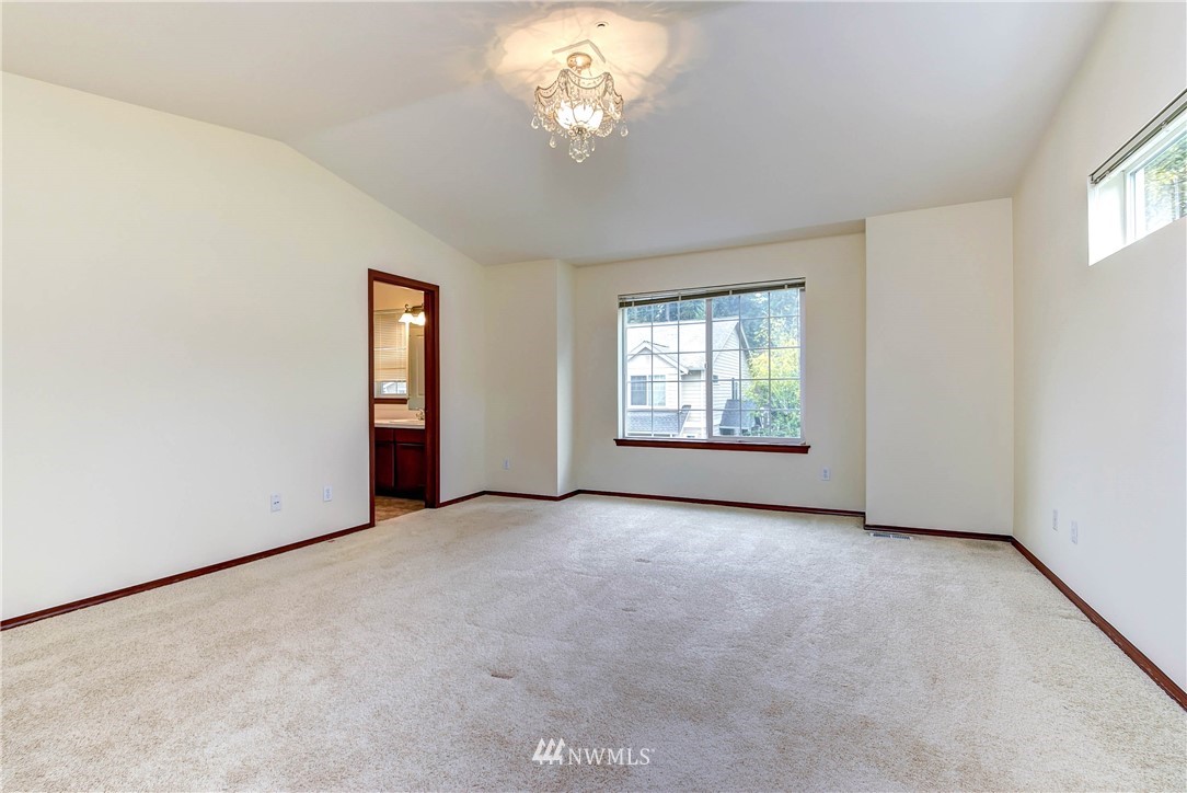 1031 215th Place Southeast Bothell, WA 98021 - Photo 16 of 25 an empty room with windows and chandelier fan