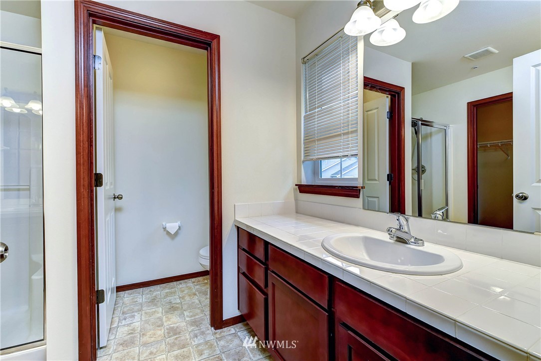 1031 215th Place Southeast Bothell, WA 98021 - Photo 18 of 25 a bathroom with a sink and a mirror