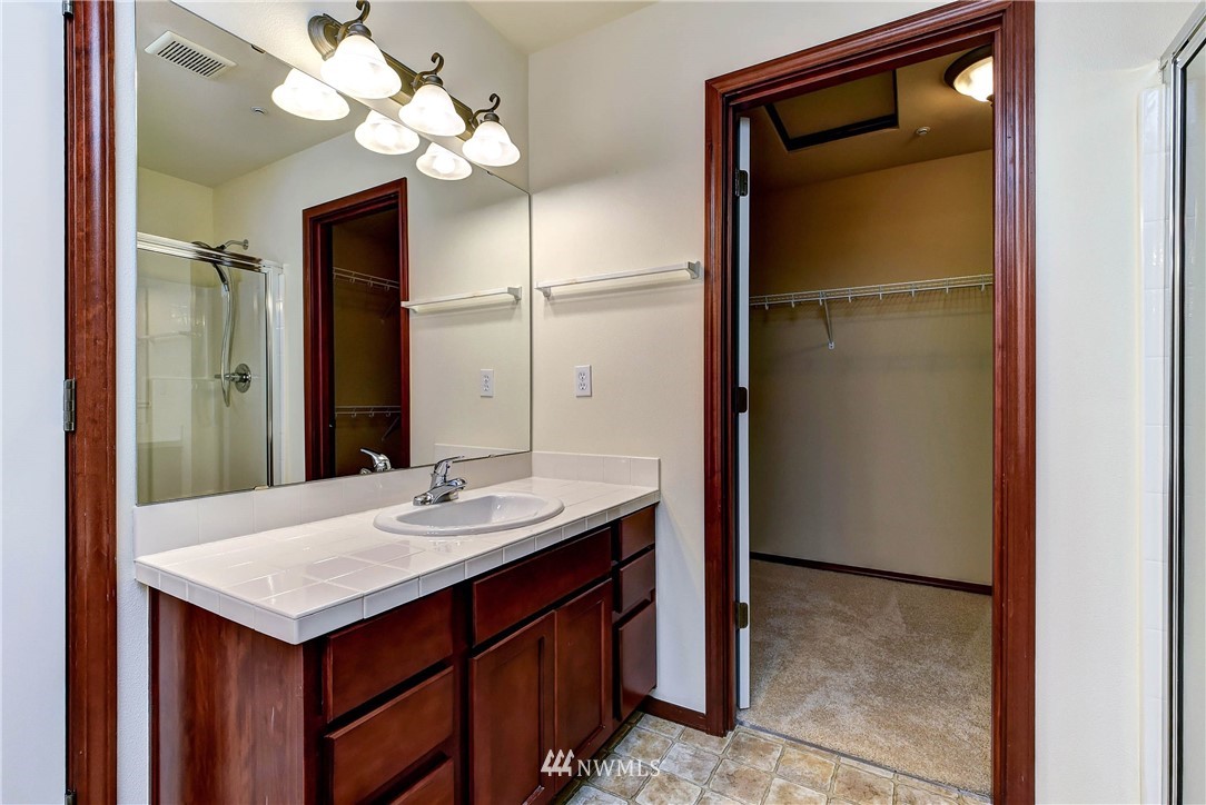 1031 215th Place Southeast Bothell, WA 98021 - Photo 19 of 25 a bathroom with a sink and a mirror