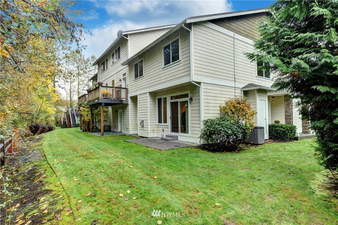 1031 215th Place Southeast Bothell, WA 98021 - Photo 24 of 25 a front view of a house with a garden and yard