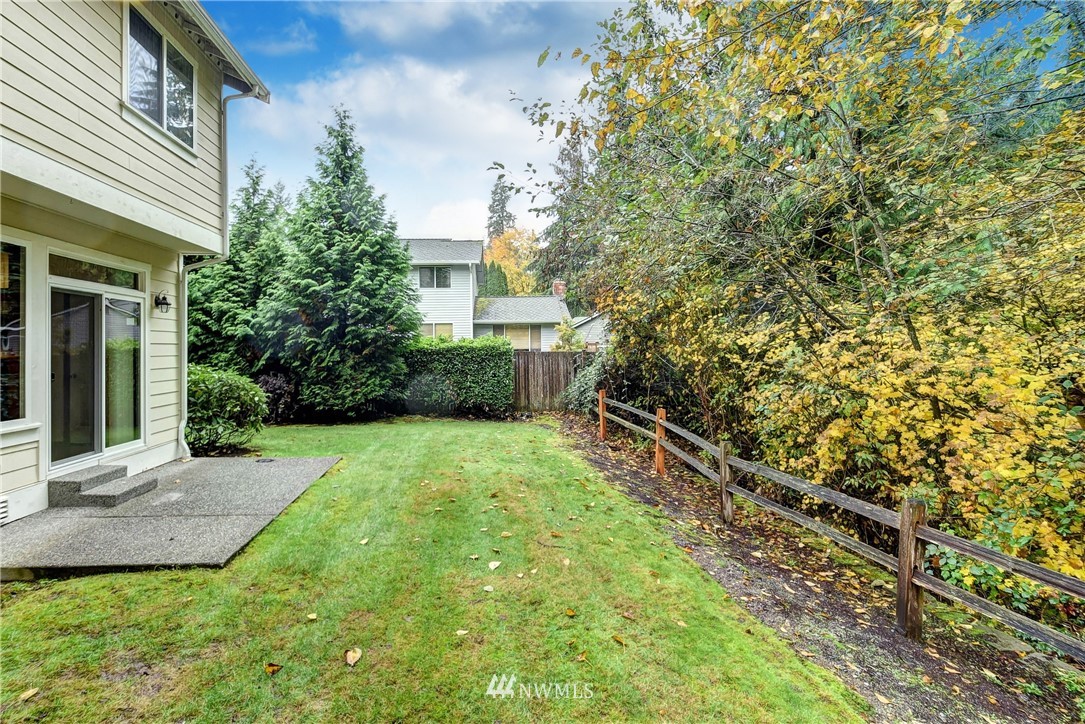 1031 215th Place Southeast Bothell, WA 98021 - Photo 25 of 25 a view of a yard with plants and wooden fence
