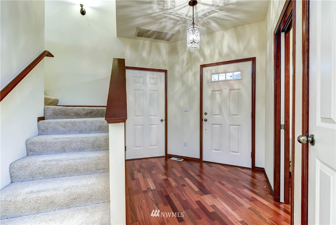 1031 215th Place Southeast Bothell, WA 98021 - Photo 5 of 25 a view of an entryway with wooden floor and stairs