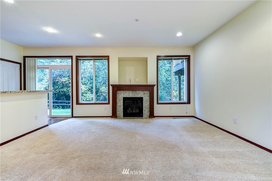 1031 215th Place Southeast Bothell, WA 98021 - Photo 7 of 25 a view of an empty room with a fireplace and a window