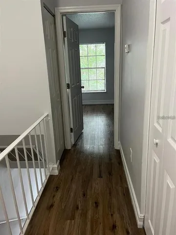 a view of hallway with wooden floor