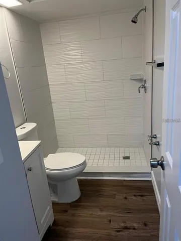 a bathroom with a toilet and a shower