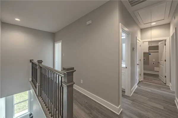 a view of a hallway with wooden floor