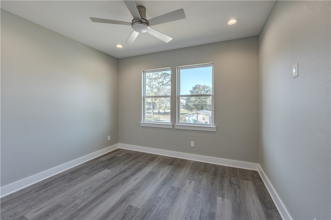 729 Ebenezer Lane Brenham, TX 77833 - Photo 23 of 25 wooden floor in an empty room with a window