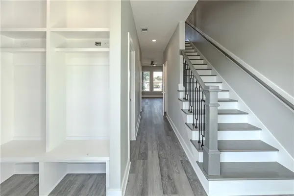 a view of a hallway with wooden floor and entryway