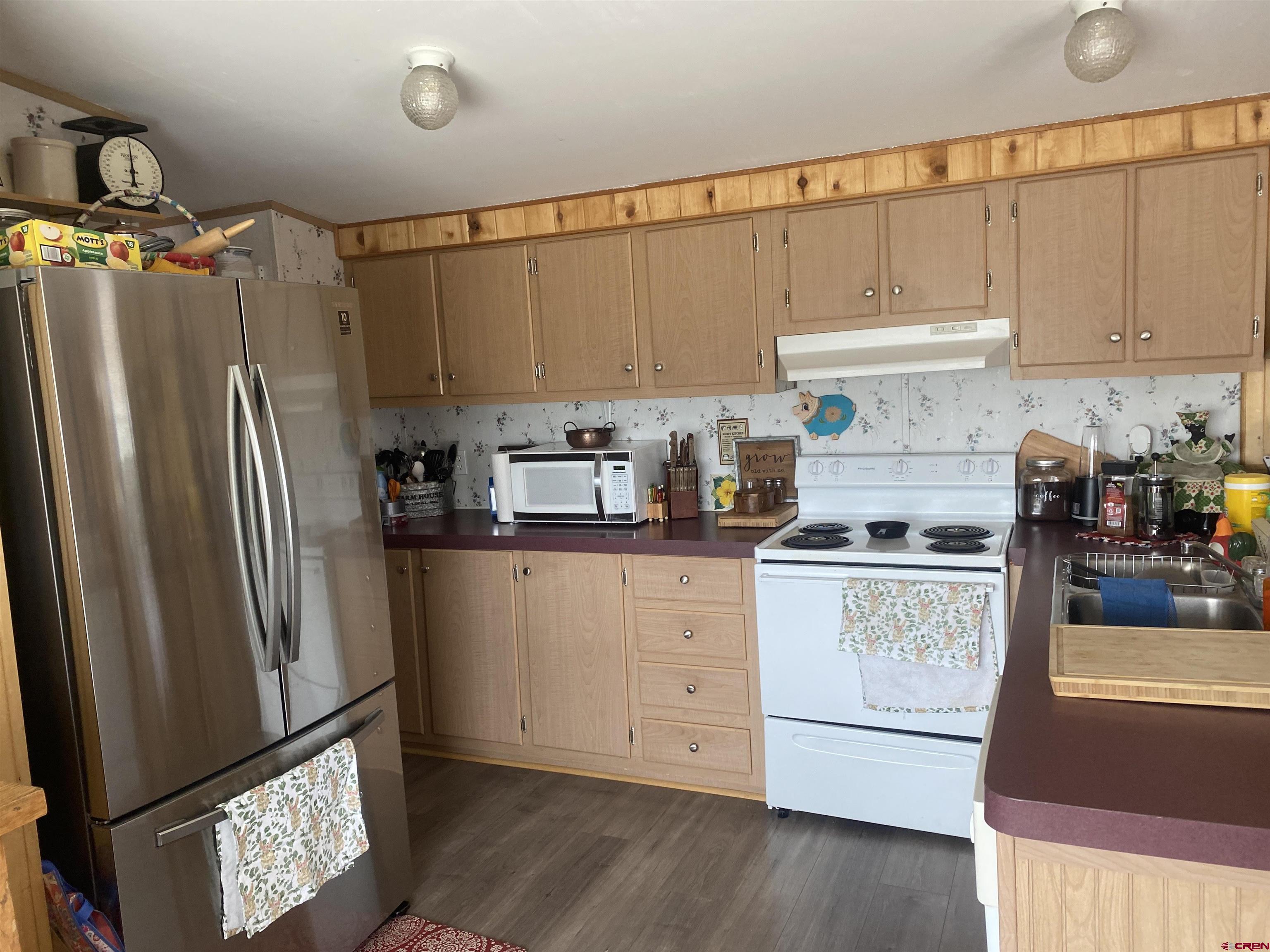 16937 2550th Road Cedaredge, CO 81413 - Photo 2 of 8 a kitchen with stainless steel appliances granite countertop a refrigerator sink and cabinets